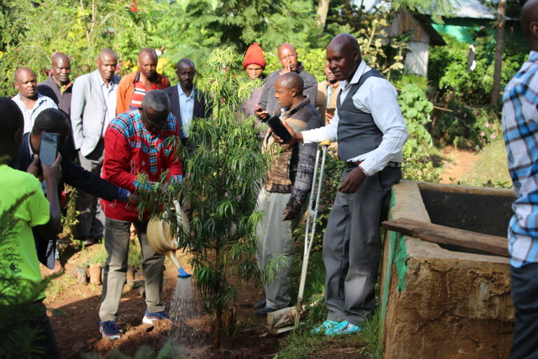 GTAP party leader waterting plant after planting in Narok